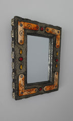 Decorative mirror with an ornate frame on a gray background