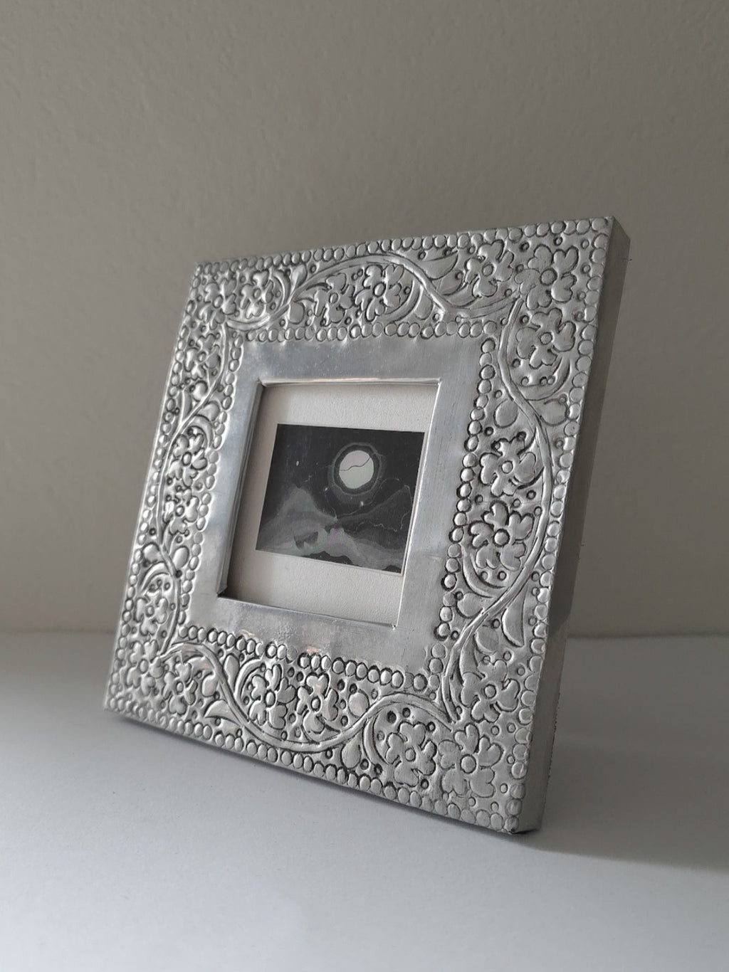 Decorative silver picture frame on a plain background