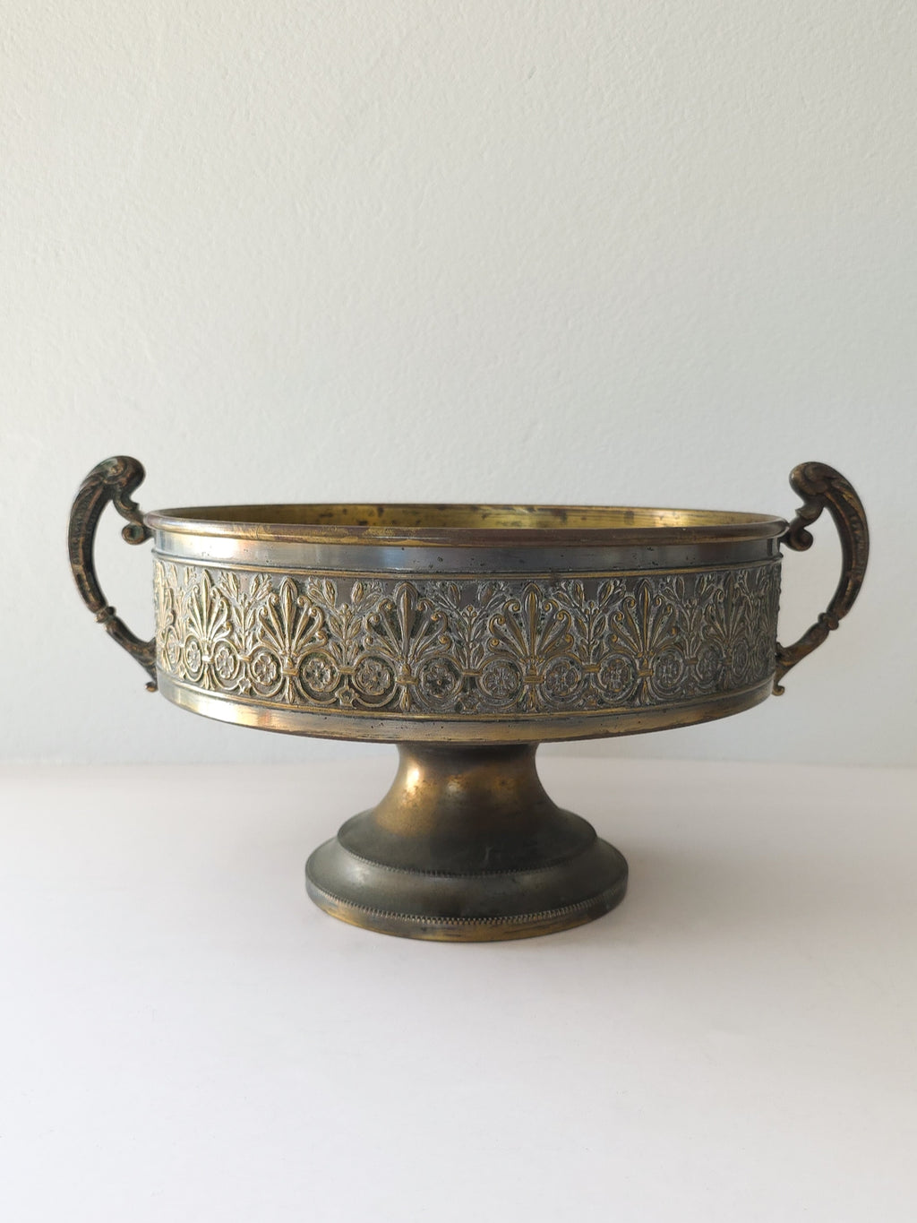 A large brass pedestal bowl