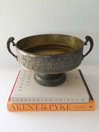 A large brass pedestal bowl