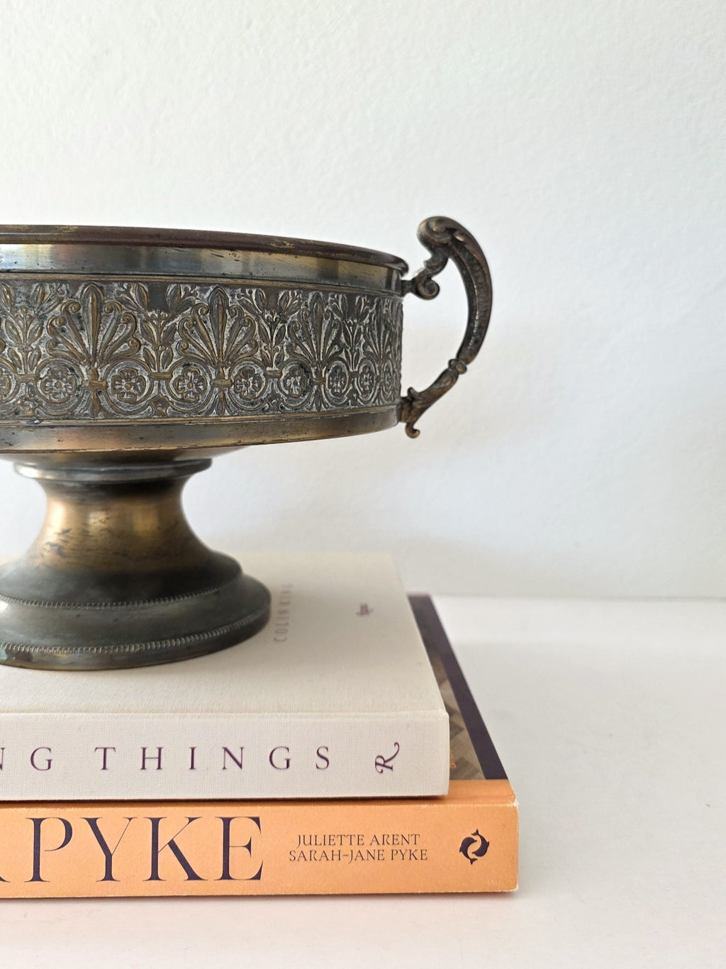 A large brass pedestal bowl