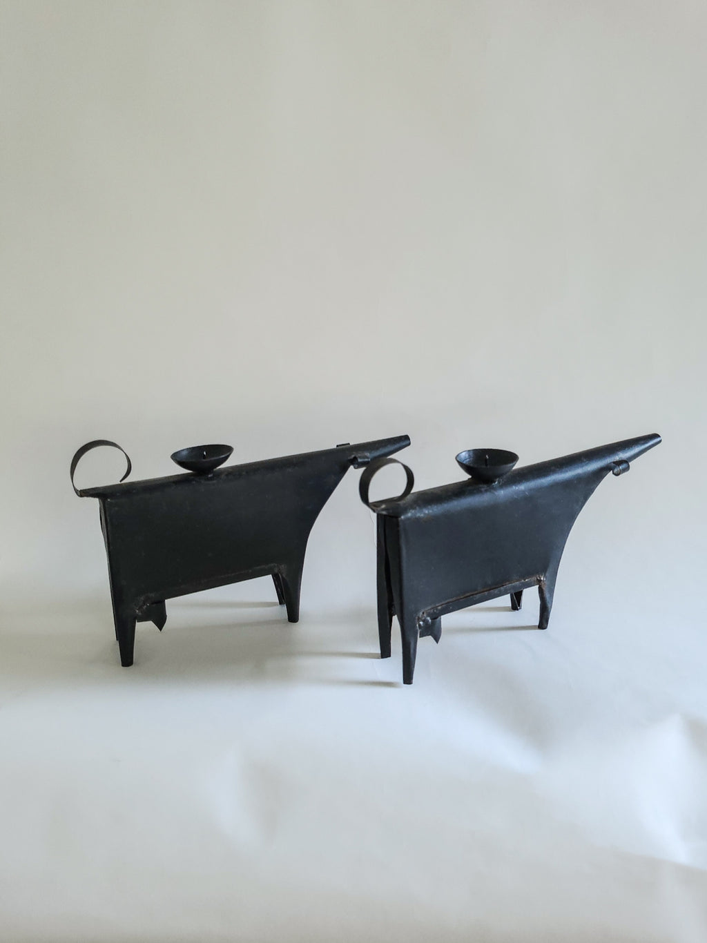 Sculptural metal cow candle holders